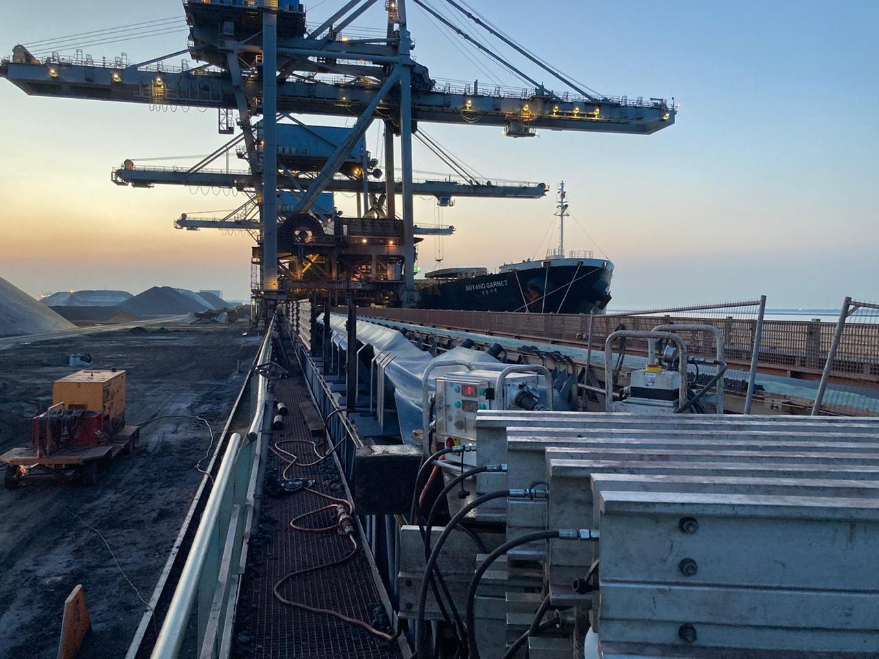 KramTec technicians working on conveyor belt installation inside an industrial facility